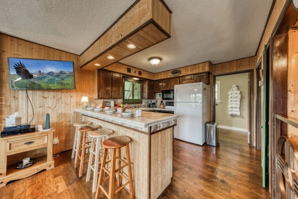 Make yourself at home in the kitchen, featuring a spacious counter, refrigerator, and all the essential amenities to prepare your favorite meals with ease