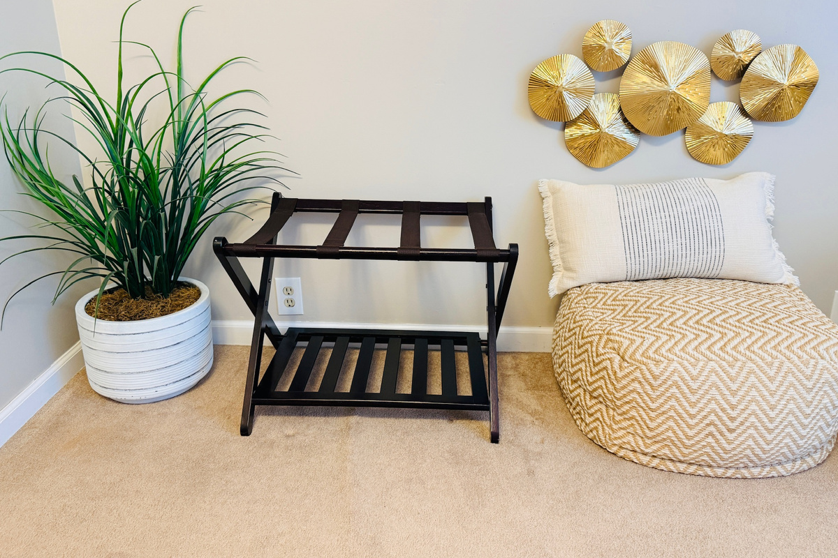 Upstairs bedroom includes a luggage rack and space for personal belongings.