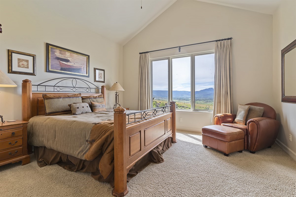 Serene primary suite with large windows and breathtaking views