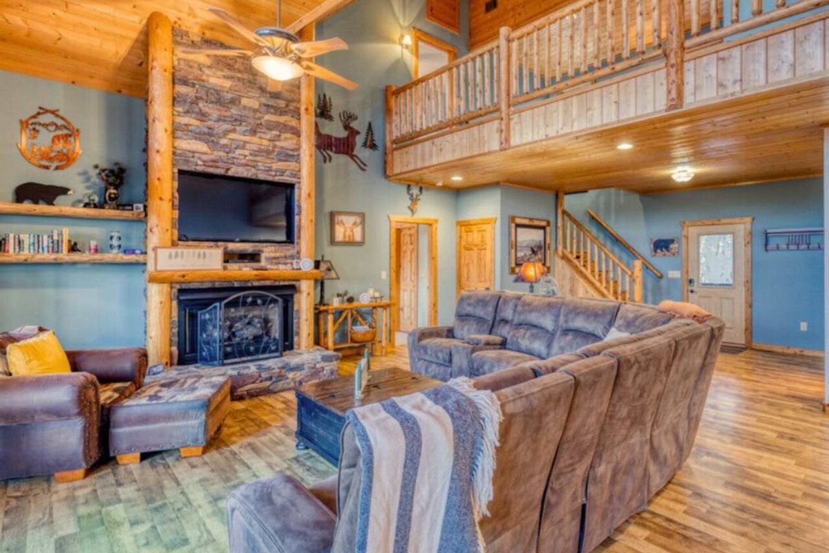 Relax in our cozy living room, complete with comfortable couches, chairs, a crackling fireplace, and a TV for your entertainment.