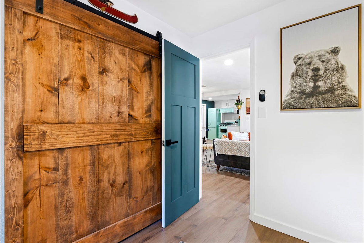 Gorgeous customer barn doors conceal the closet.