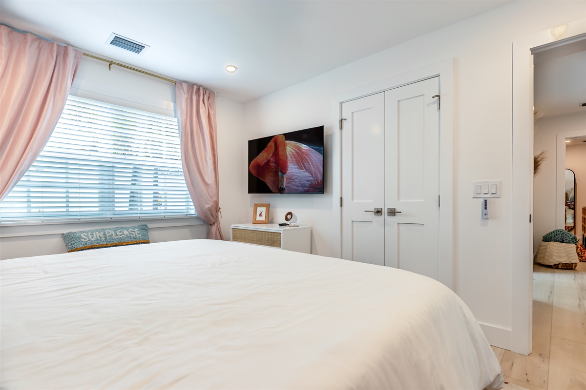 Charming Bedroom Retreat: Bright space with a comfortable bed and vibrant art to inspire relaxation!
