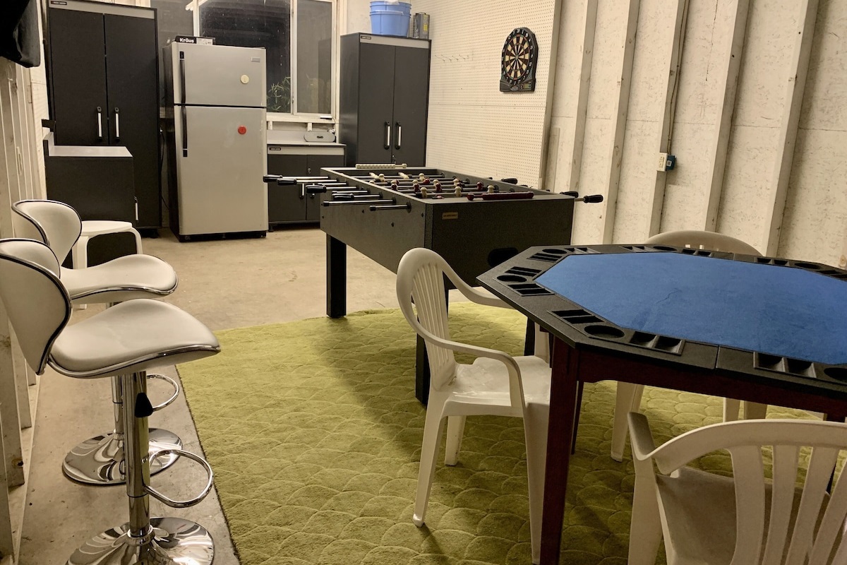 The man cave garage includes a poker table, foosball and dartboard!