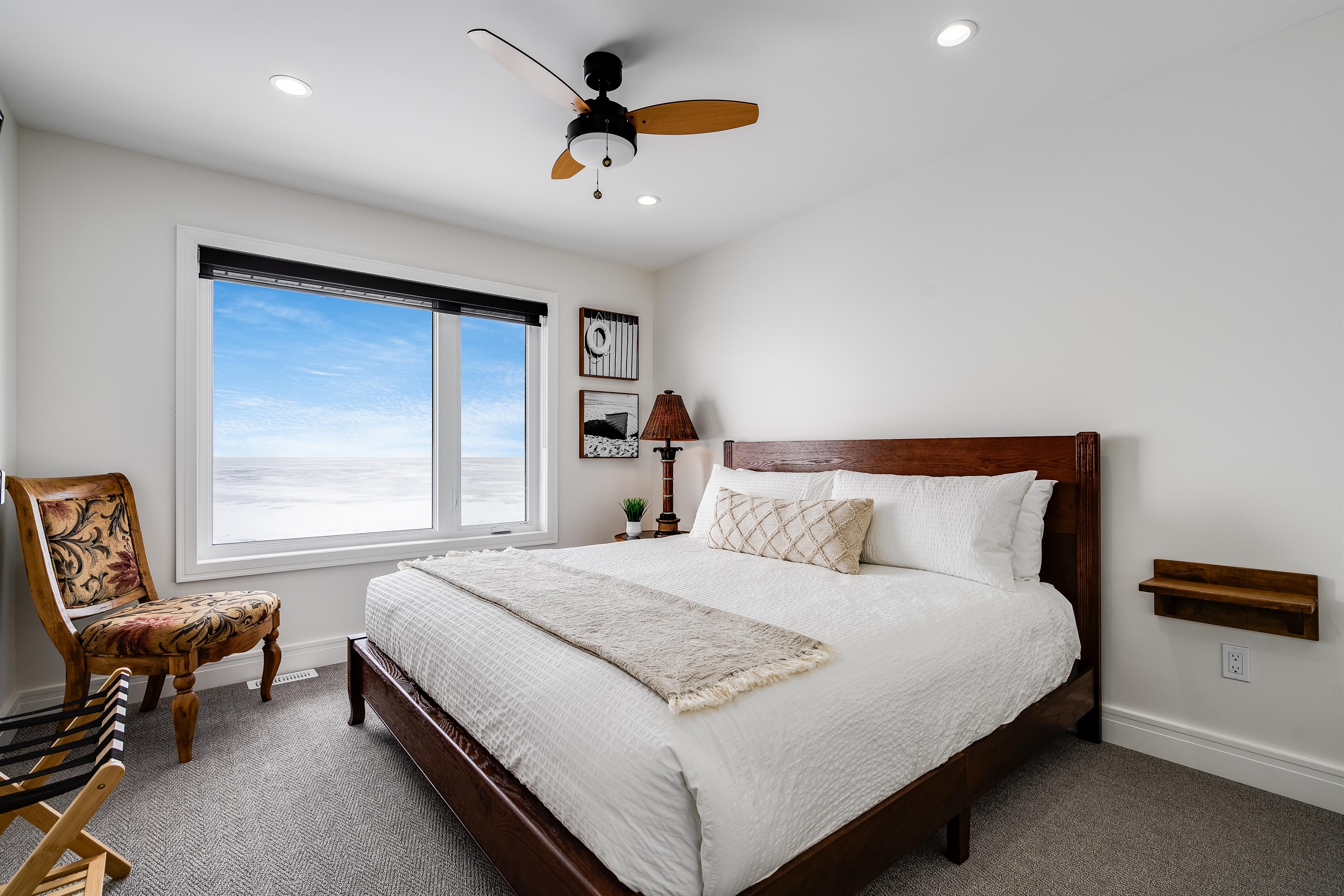King Bedroom with, Natural wood bed frame grounds the space.