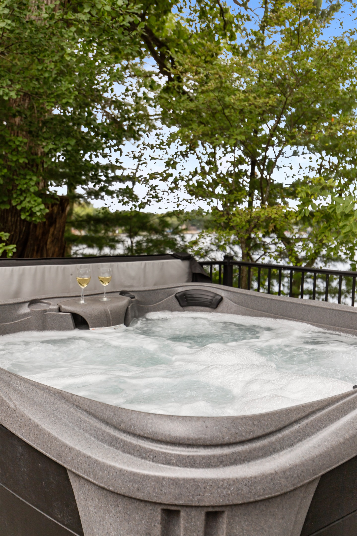 Soak in the hot tub while taking in serene views of the lake just steps away.
