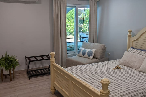 Here is the view of the 2nd bedroom from the door. Comfy chair that looks out at the pool if you want to relax with a book.