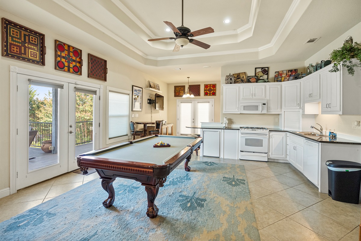 Spacious game room with pool table, ping pong, and a variety of board and yard games, perfect for all ages.