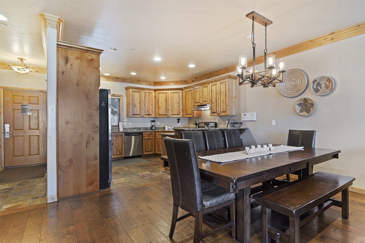 Open dining and kitchen area with ample seating and rustic finishes.