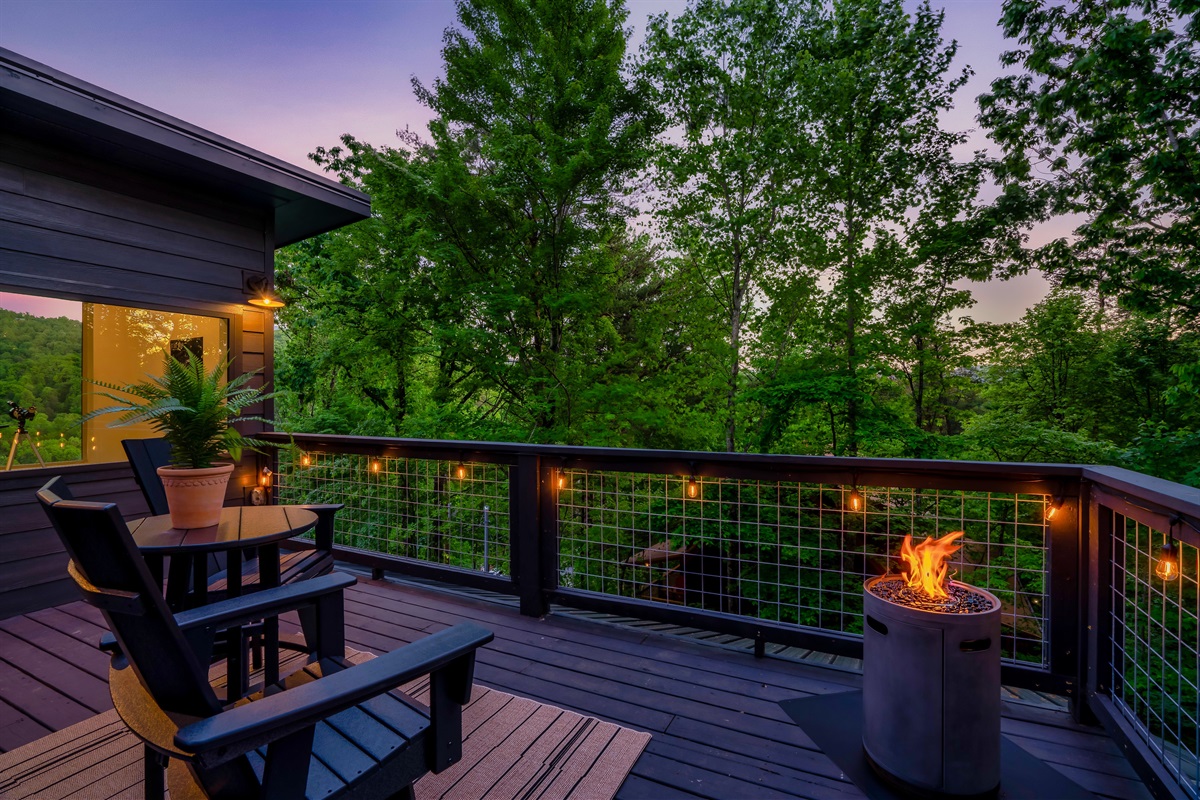 Roof top terrace with a propane fire tower and swivel chairs