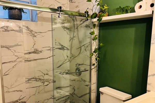 Bathroom with glass shower and modern tile design.