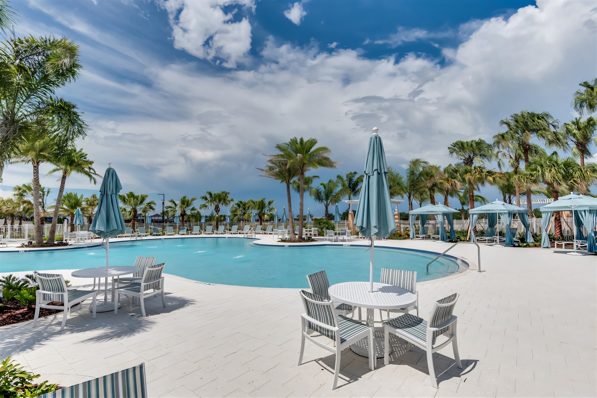 Poolside Oasis: Dive into relaxation at this sparkling pool surrounded by palm trees!