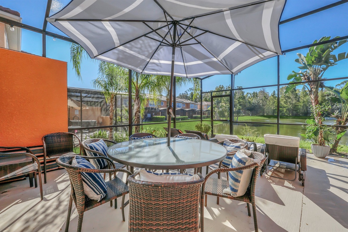 Private covered lanai with seating area, hot tub and lounge chairs