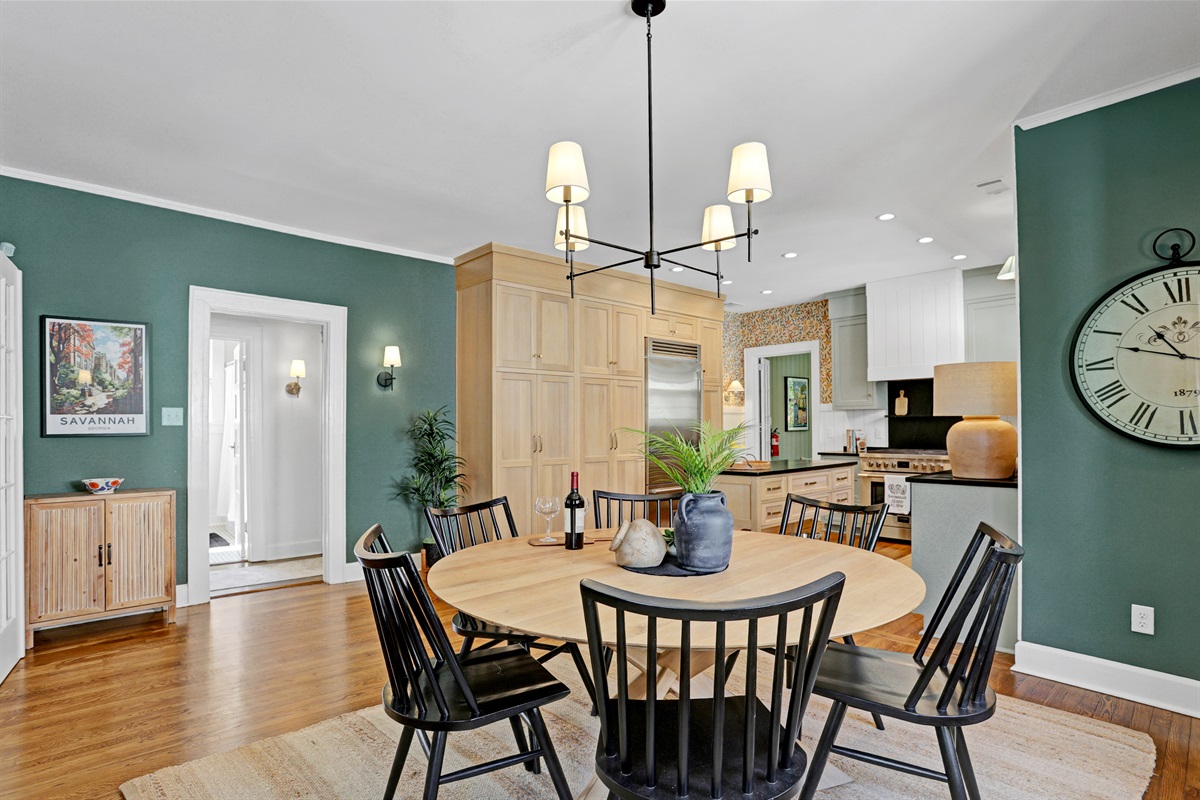 Surrounded by natural light and stylish decor, the dining space blends casual comfort with timeless charm.