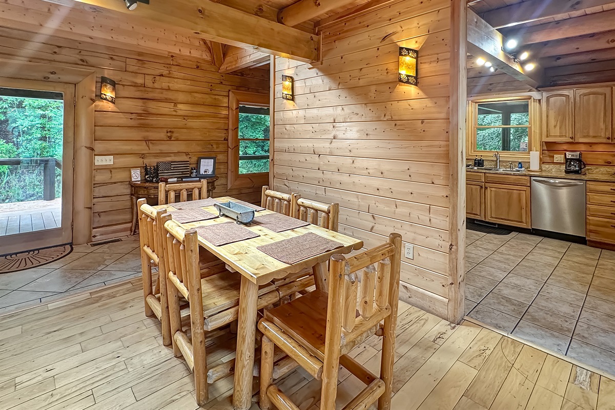 Dining Room: Gather around the rustic log table and enjoy nature views through the spacious windows!
