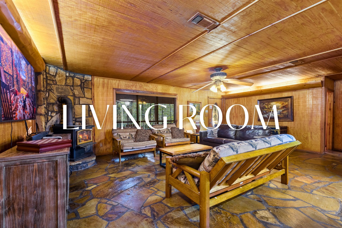 Living room with comfy seating and warm cabin vibes.