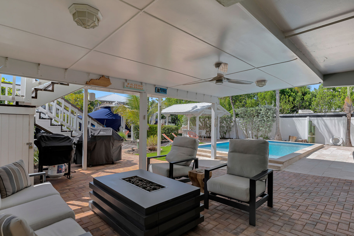 Downstairs covered lounge area with fire table
