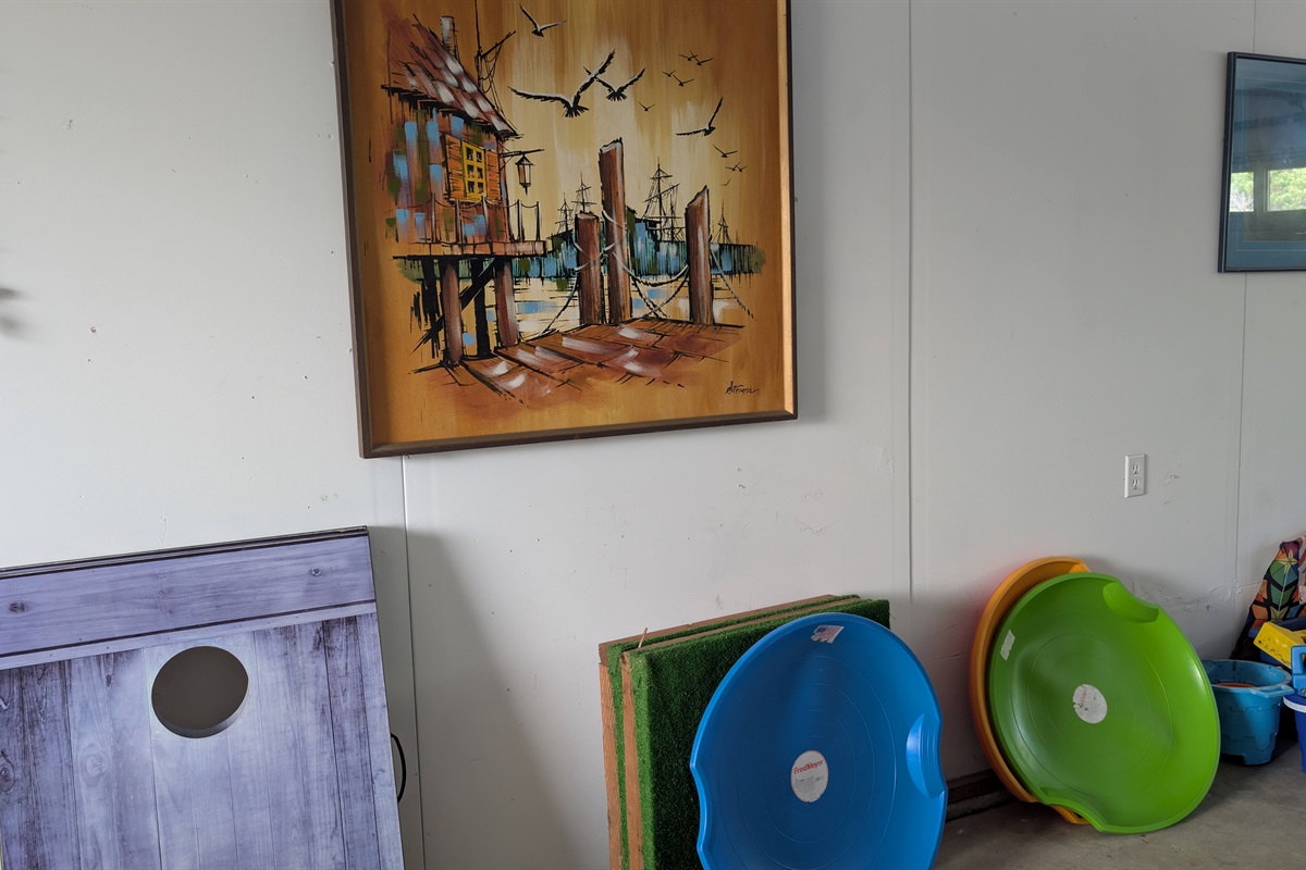 Other games and beach toys in the garage.  Cornhole, sand saucers sand castle building toys