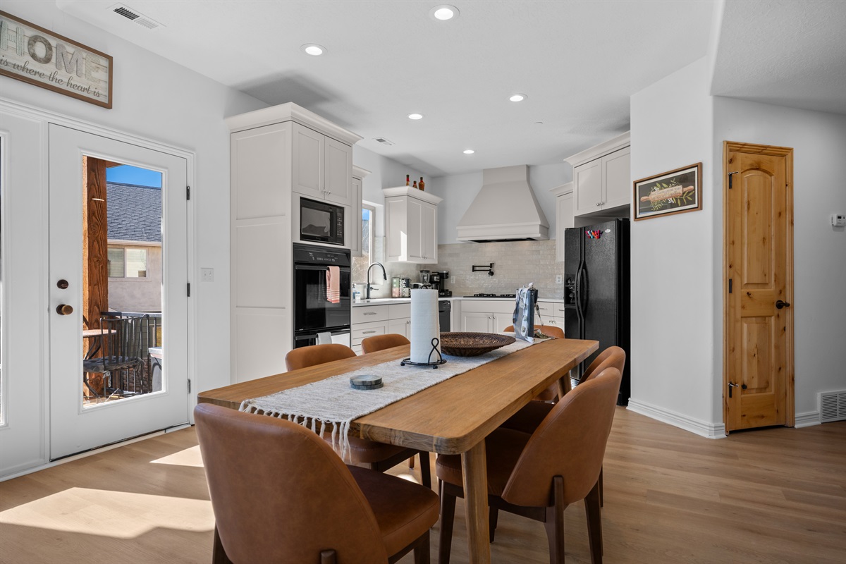 The dining table seats 6 with direct access to the balcony.