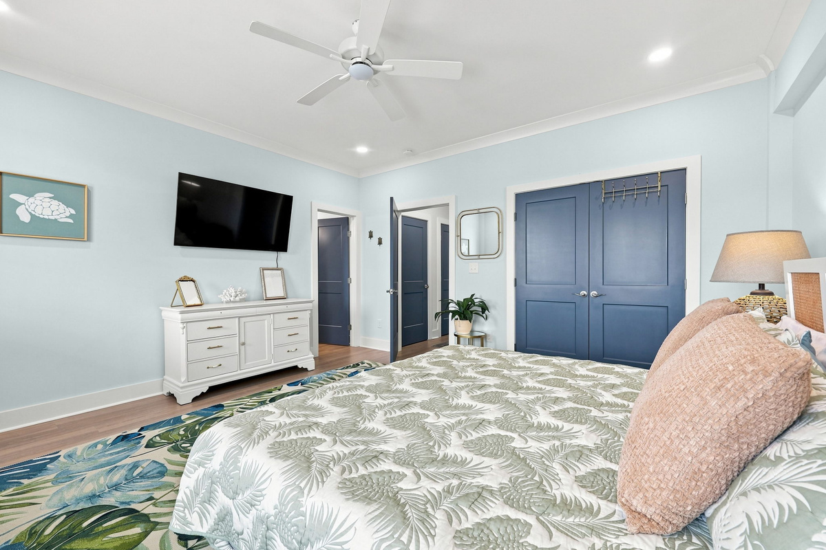 Relaxing ground floor bedroom with king bed, smart TV, and a welcoming coastal design perfect for unwinding
