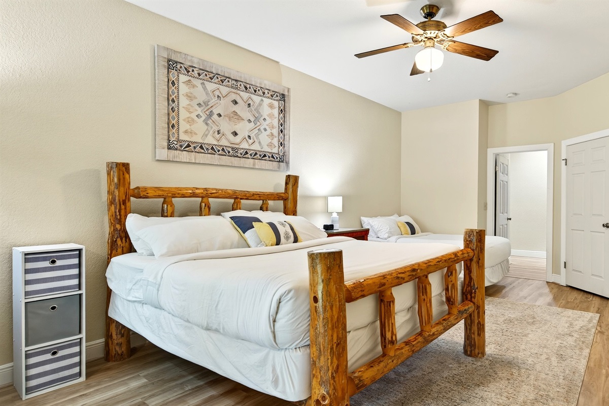 Lower level bedroom with a king size bed and full size bed.