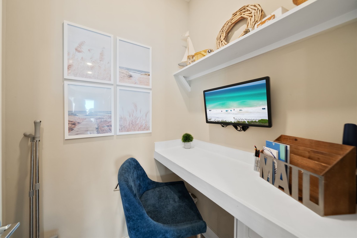 Small private workspace with monitor for guest use.