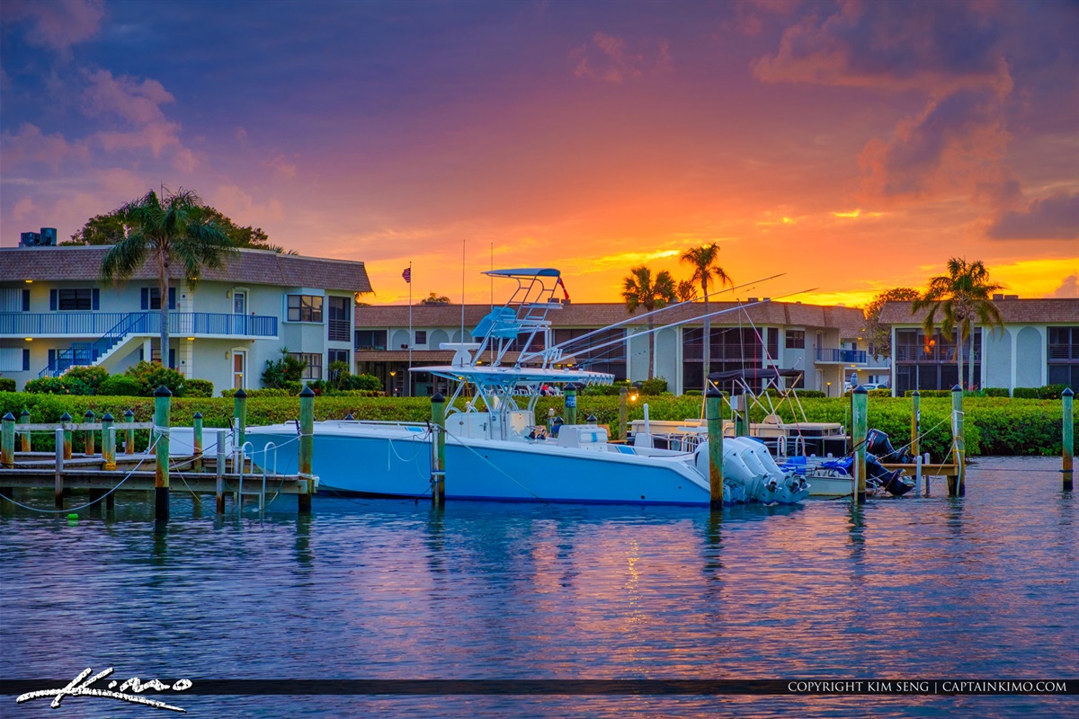 Golden skies reflect off the tranquil intracoastal as luxury boats rest at the dock- capturing the peaceful beauty of a Jupiter evening. Perfect for sunset strolls and waterfront living at it's finest