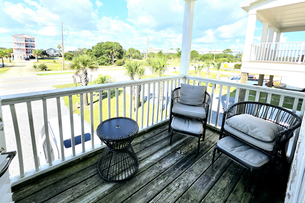 Covered balcony seating with neighborhood views