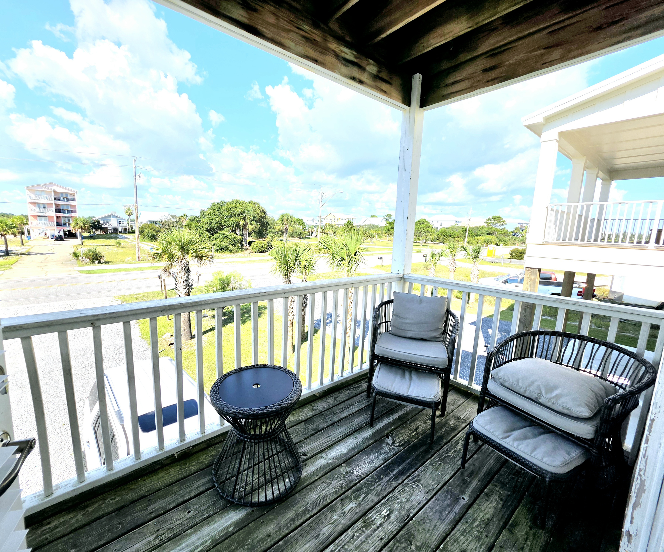 Covered balcony seating with neighborhood views