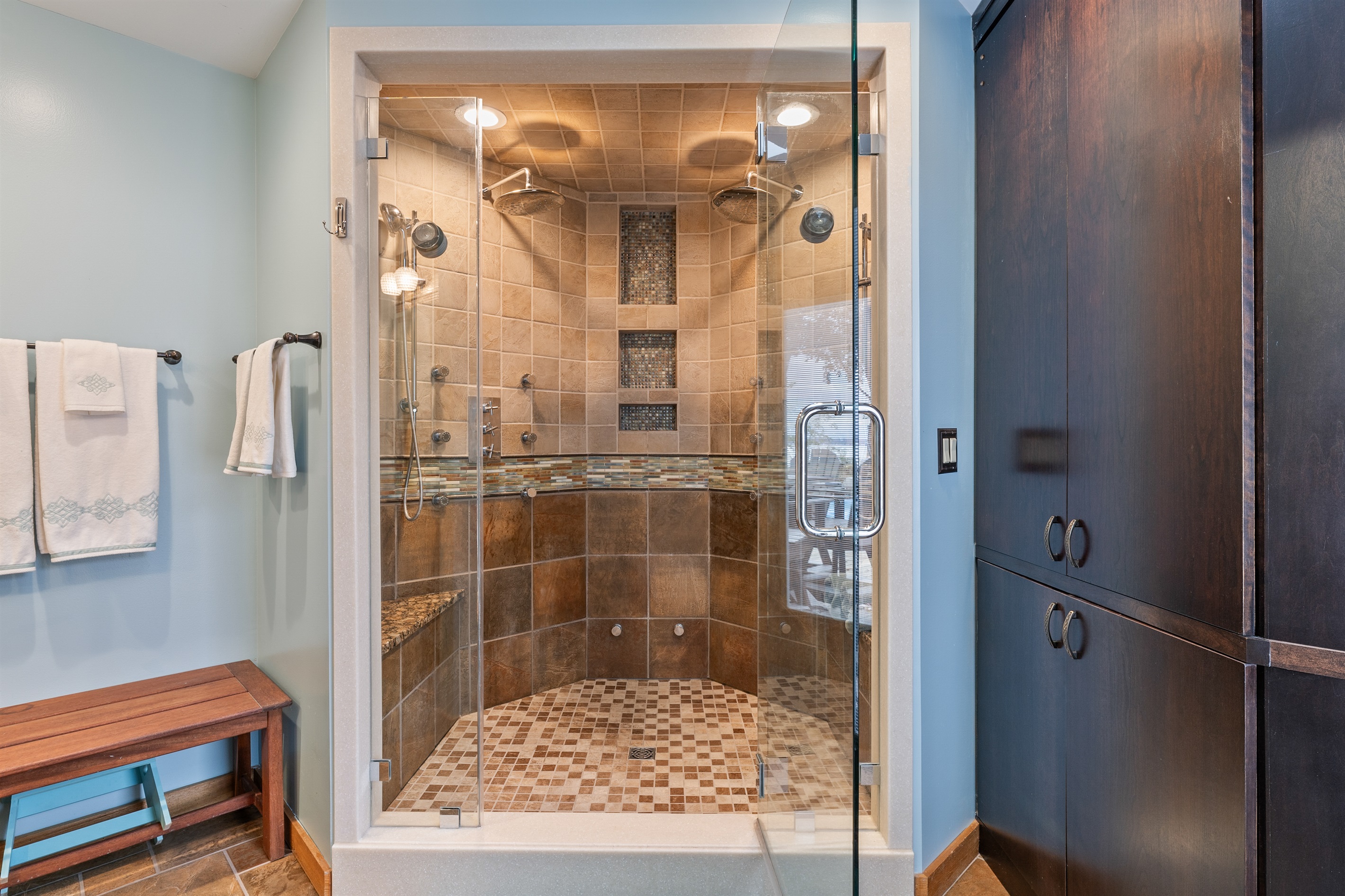 Spa-style shower with glass doors and rainfall head – unwind in style.