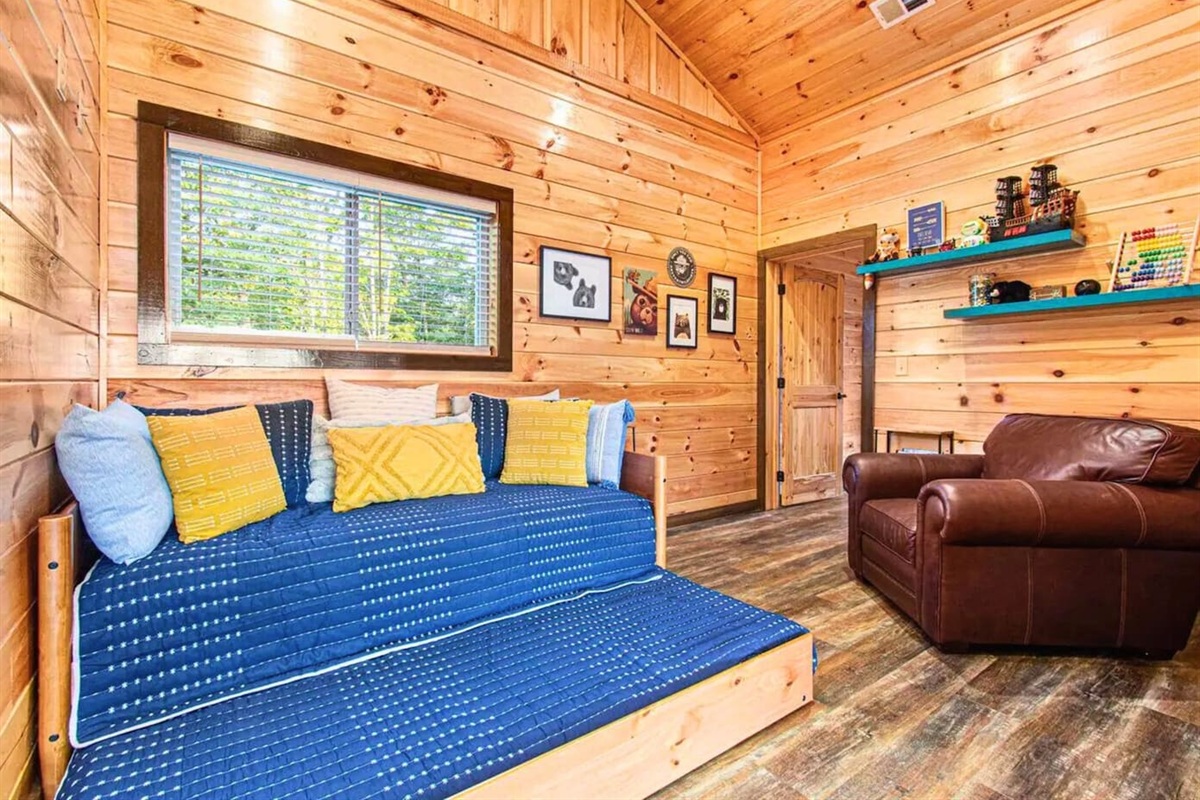The Seating Area Between the Lounge and One of the Bedrooms Has a Large Leather Chair to Relax in and a Trundle Bed for an Additional Sleeping Arrangement