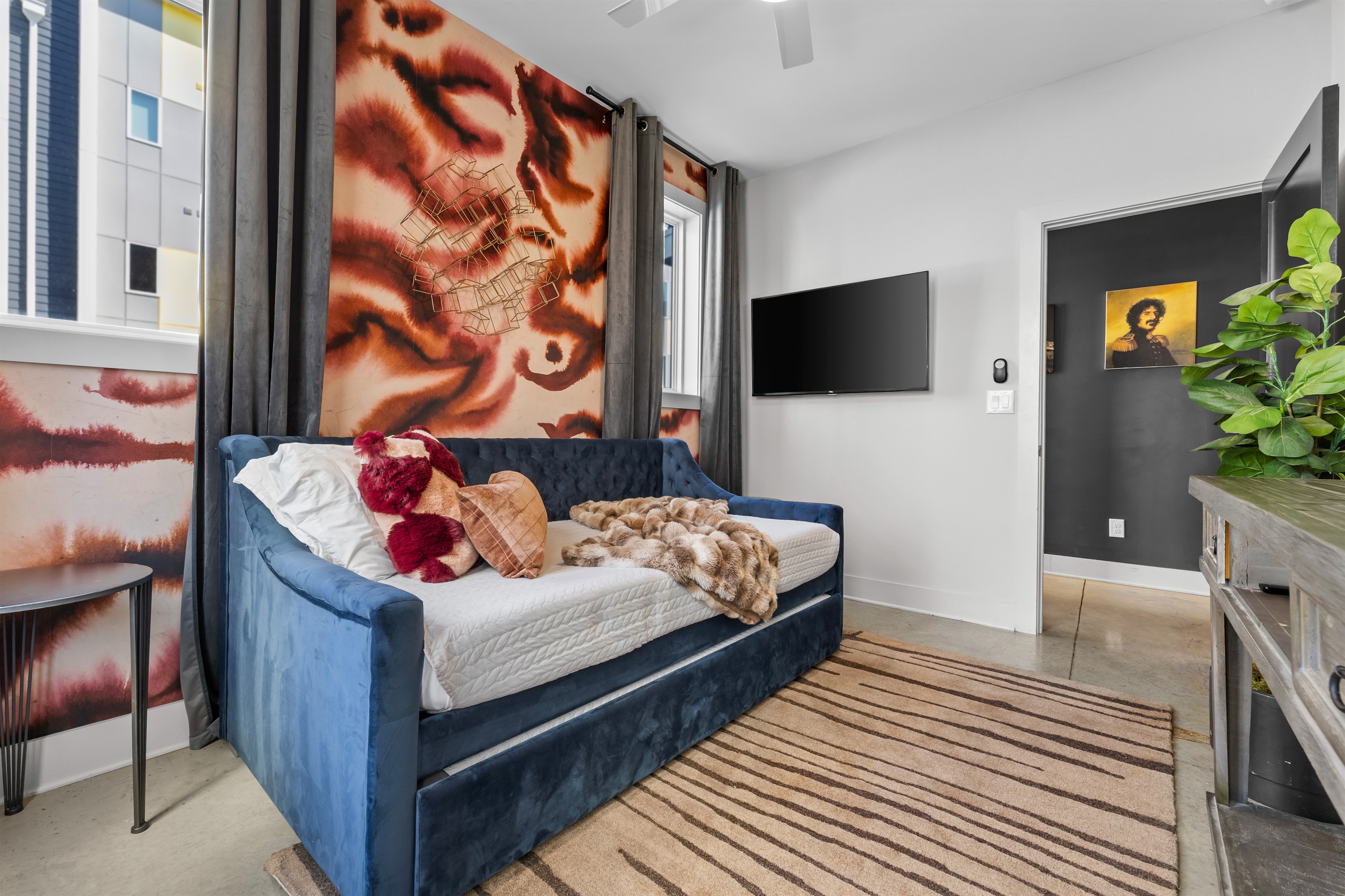 Chic Guest Room: Vibrant decor, plush daybed, and a sleek TV await your Nashville retreat!