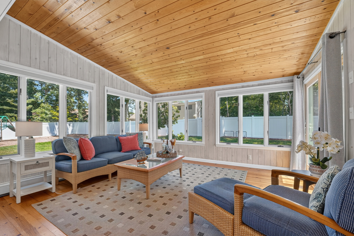 Sun-filled four-season room, perfect for morning coffee or evening conversations.
