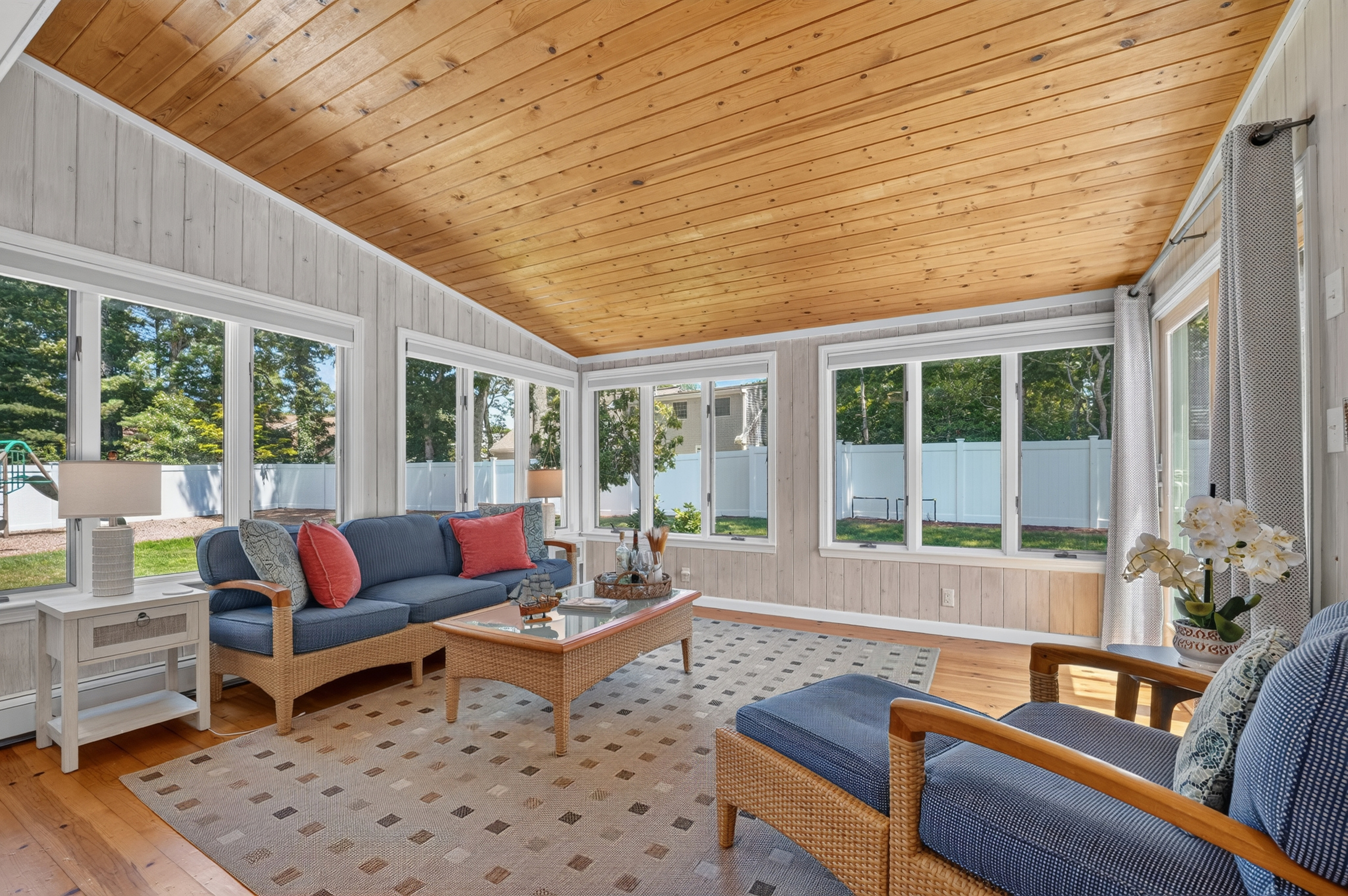 Sun-filled four-season room, perfect for morning coffee or evening conversations.