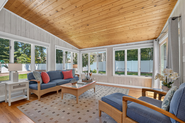 Sun-filled four-season room, perfect for morning coffee or evening conversations.