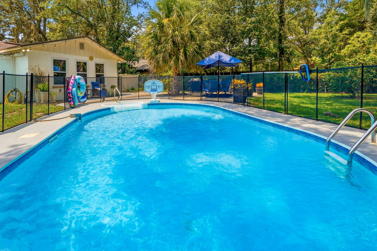 The fenced private pool offers plenty of room for swimming, floating, and enjoying the Florida sunshine.