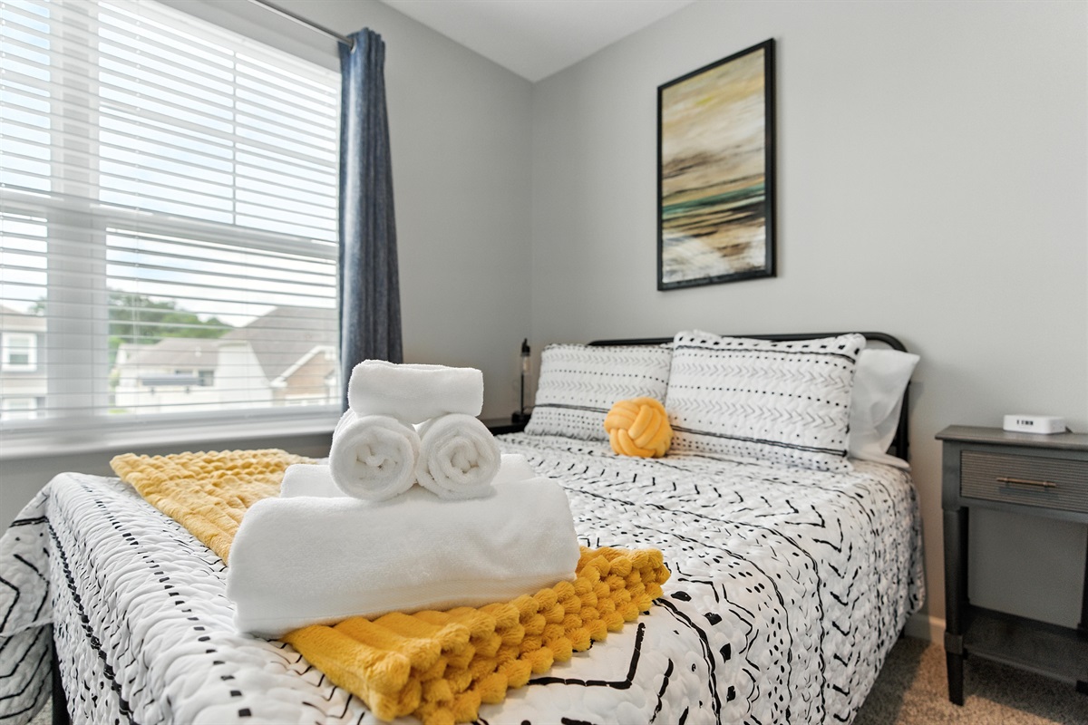 Comfortable bedroom with a full bed and fresh towels