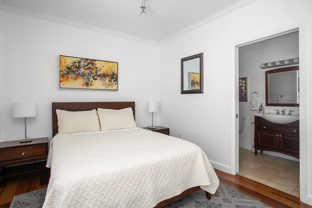 Guest Suite with en-suite bath, closet storage, and room-darkening curtains