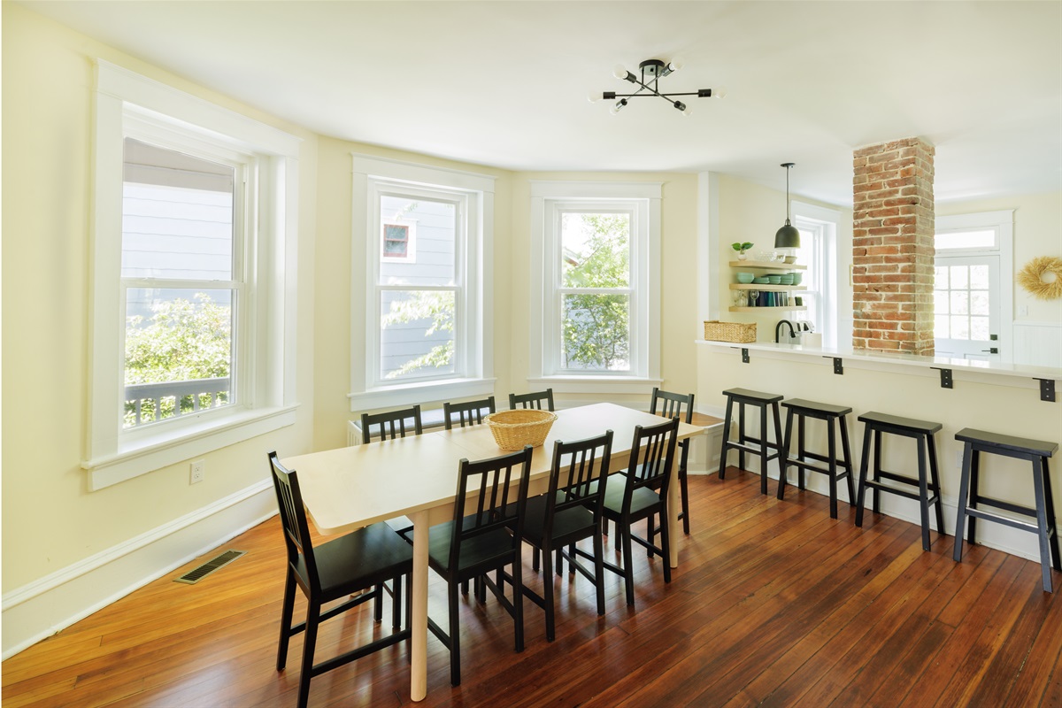 Large dining area with seating for eight at the kitchen table and four at the bar.