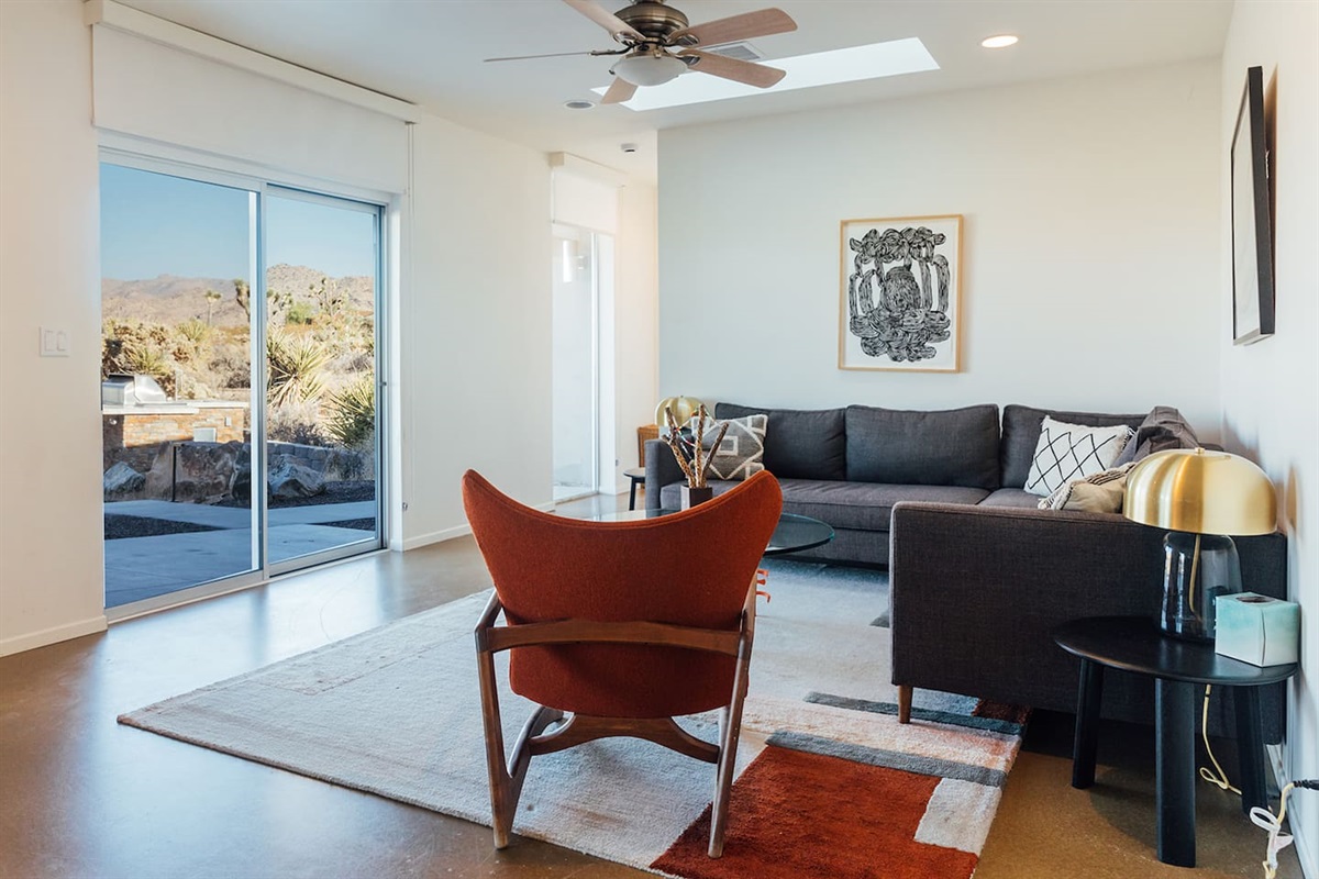 Relax in the second living room with cozy seating and glass doors that open to sweeping desert and patio views.