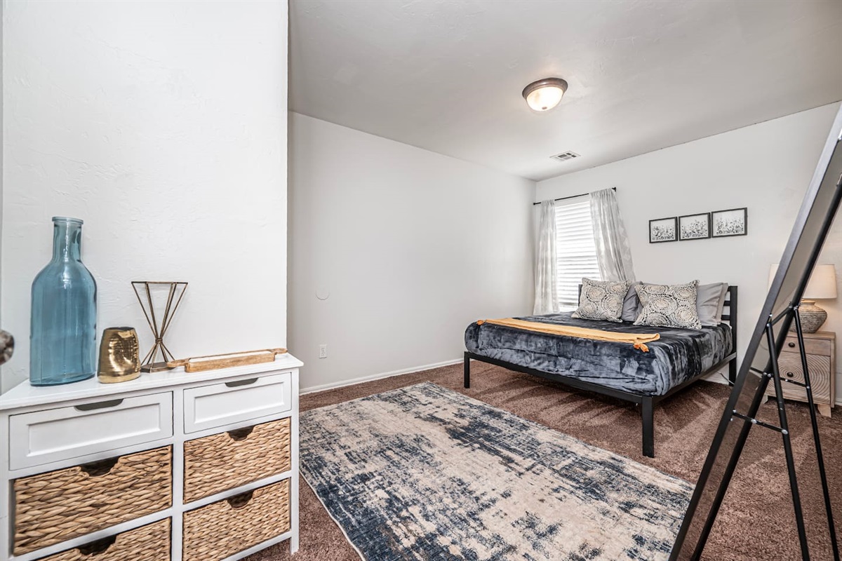 Relax in this stylish secondary bedroom with a comfortable queen bed.