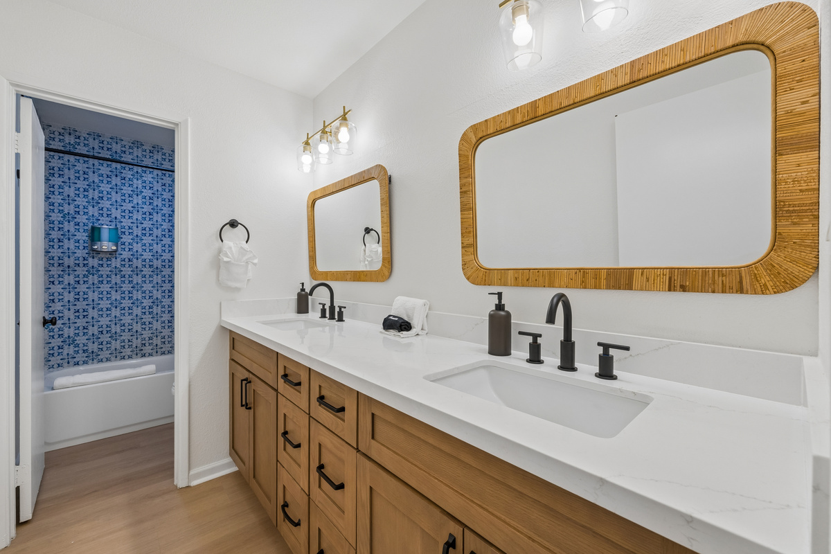 This hall bathroom has a separated tub/toilet room so everyone else can get ready at the expanded dual vanity!