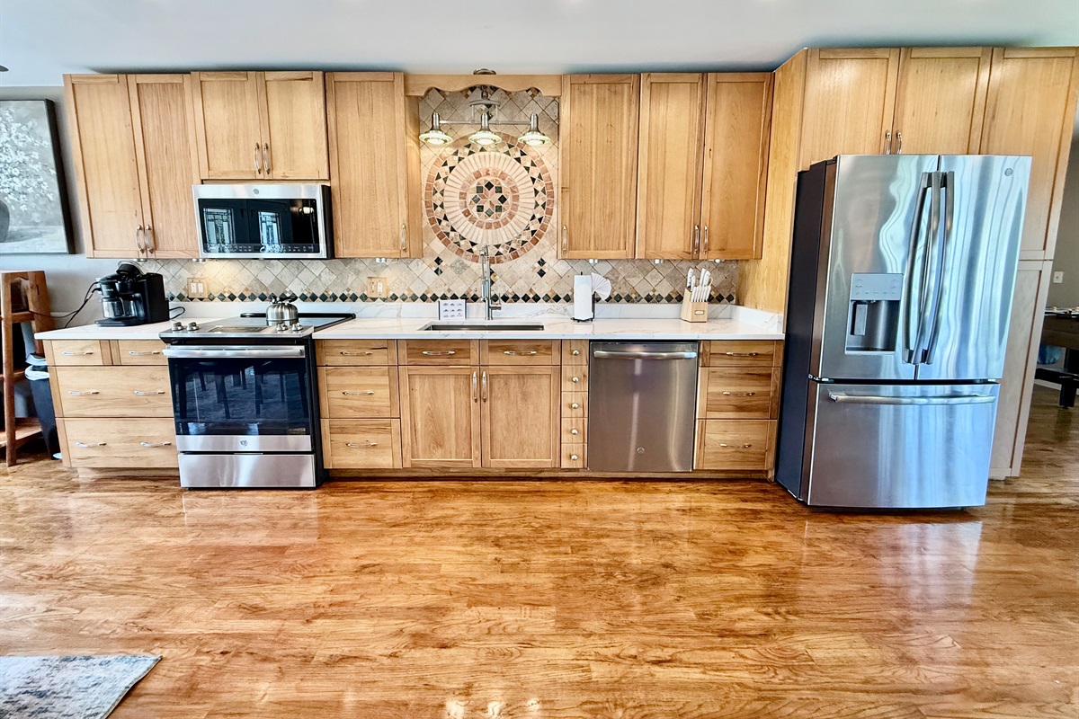Whether you're prepping snacks for the beach or cooking a family meal, this updated kitchen offers space, storage, and top-notch appliances to make it effortless.