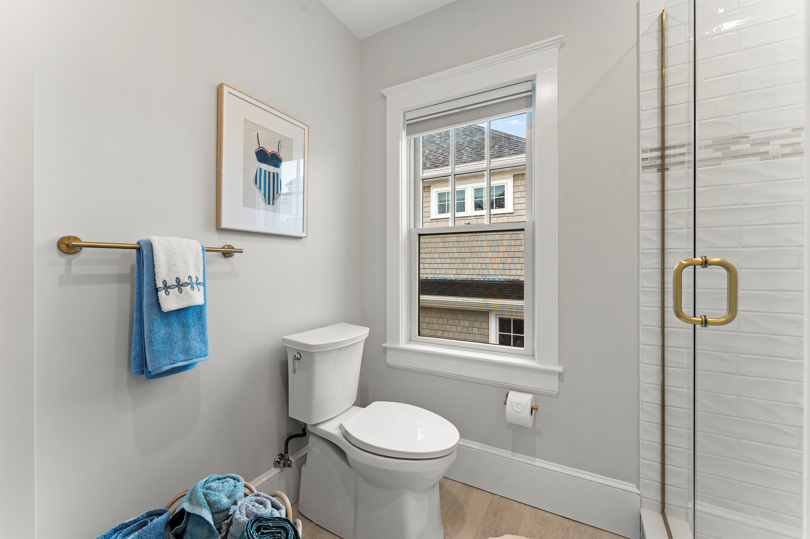Modern full bathroom featuring a walk-in shower and toilet.