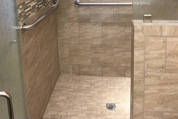 The Handicap-Accessible shower in the primary bedroom