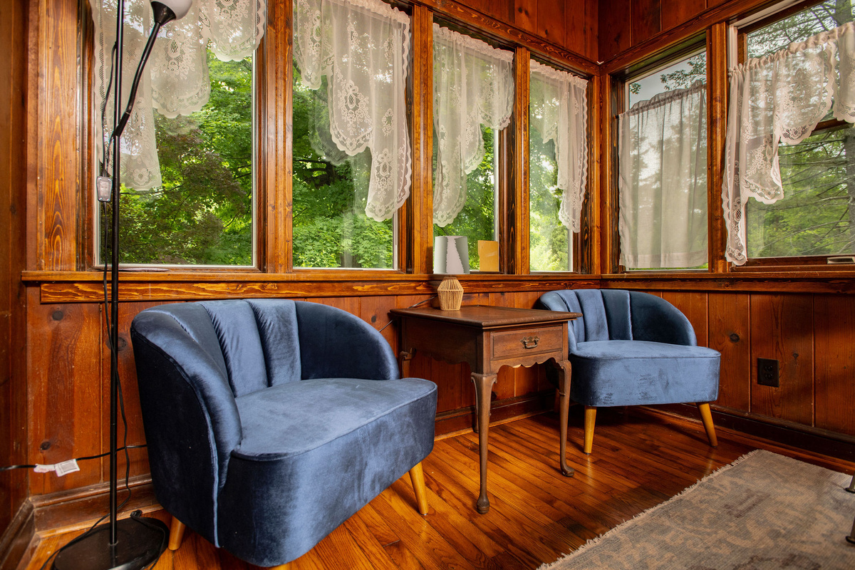 Reading nook with velvet chairs, perfect for morning coffee among the trees