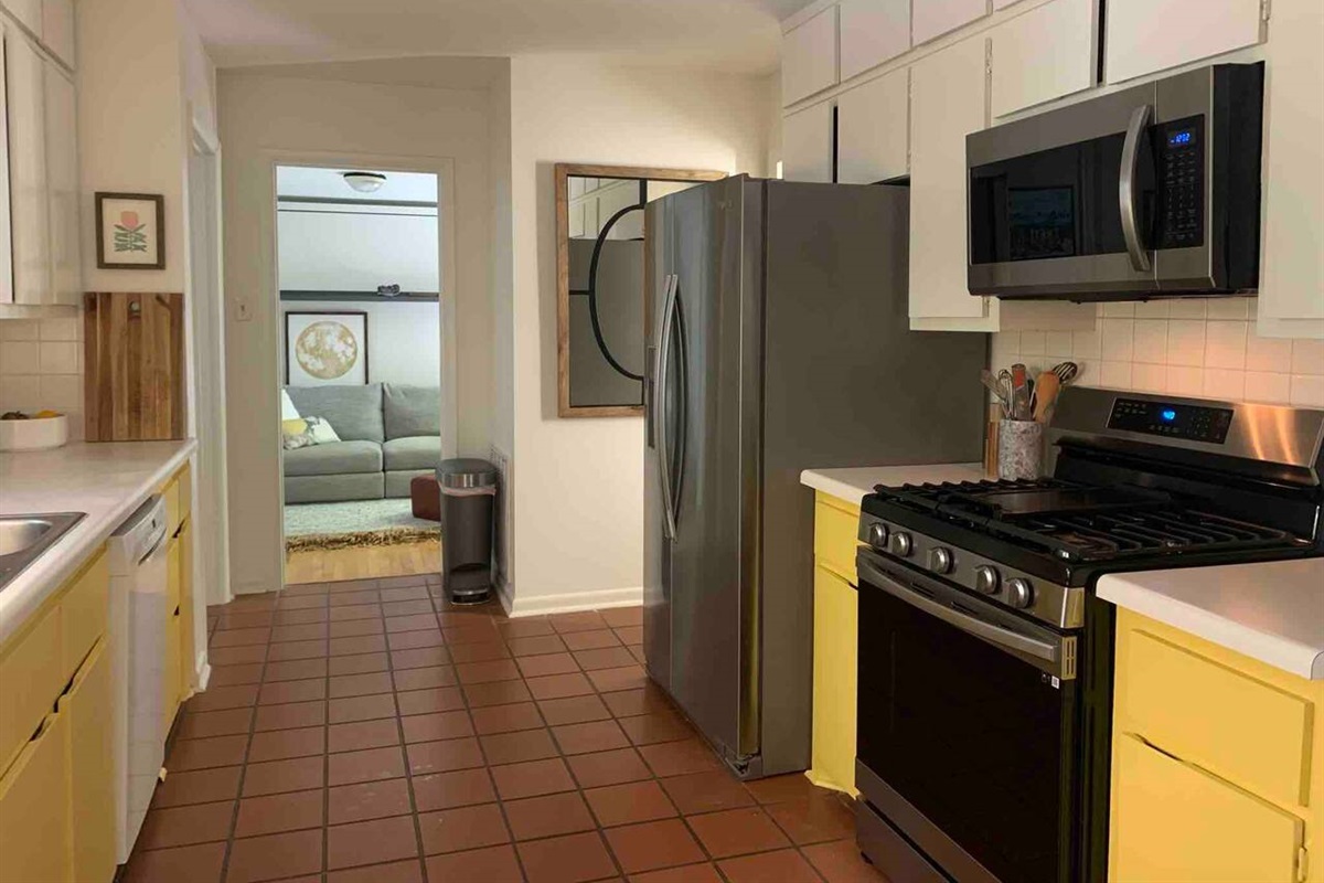 Another look at the galley kitchen &mdash; stainless appliances, real cookware, and everything a home cook needs to actually cook.