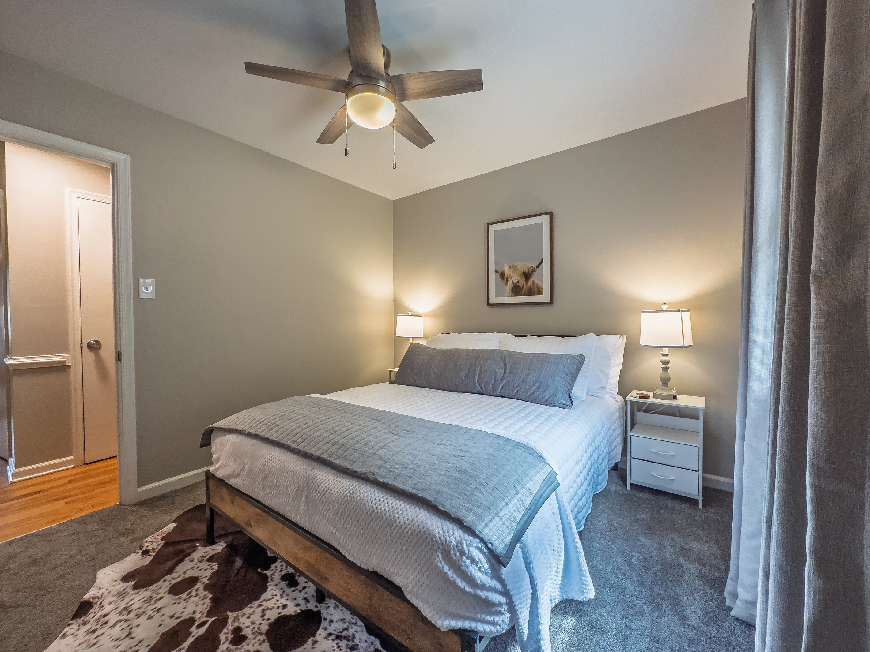 Queen bed, 55" Smart TV, ceiling fan, two led-light nightstands with multiple charging ports, two multi-light function lamps, blackout curtains, and full closet.