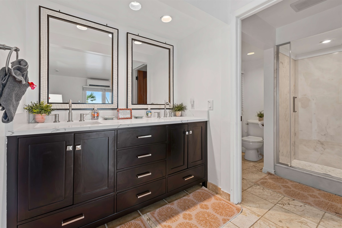 The ensuite bathroom of the king/twin guest suite has double sinks and private shower/toilet area - perfect for two guests sharing the room.