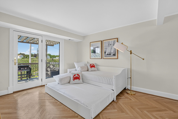 A peaceful, light-filled bedroom designed for comfortable nights and easygoing beach days.