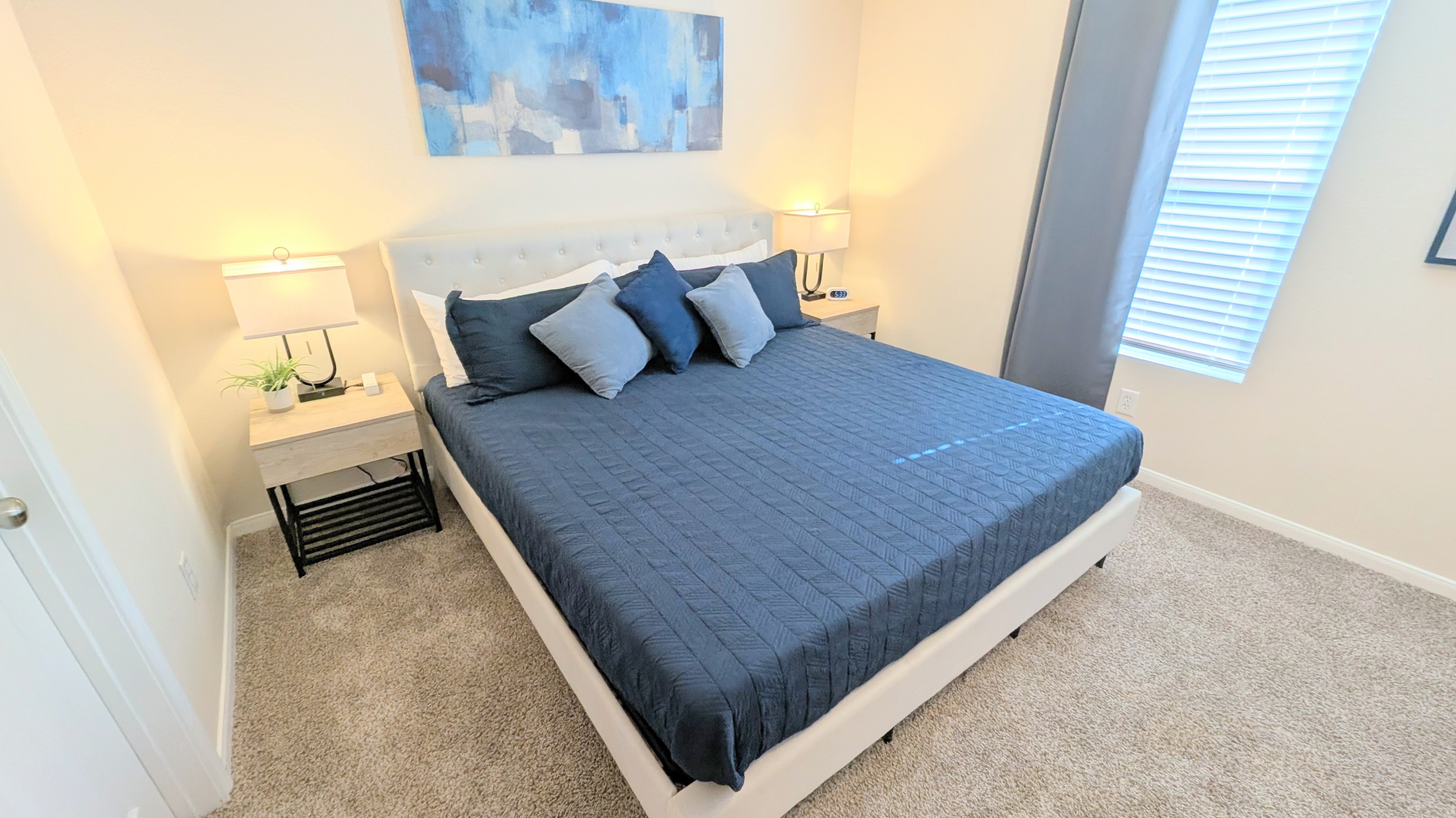 Sleep well in this comfortable space with King bed, ceiling fan, blackout curtains, and plush bedding. 